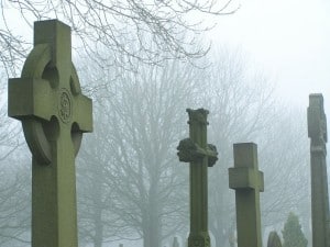 Foggy cemetery with tombstones 